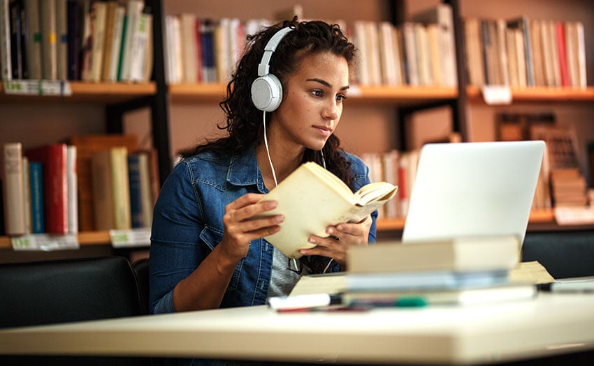 college-student-in-library-with-headphones