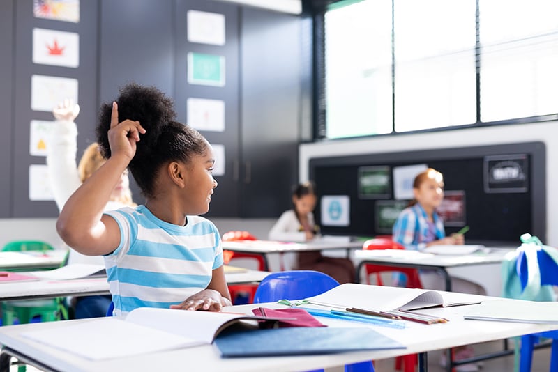 young-k12-student raising-hand-in-class_AdobeStock_619675167_800px-x-534px