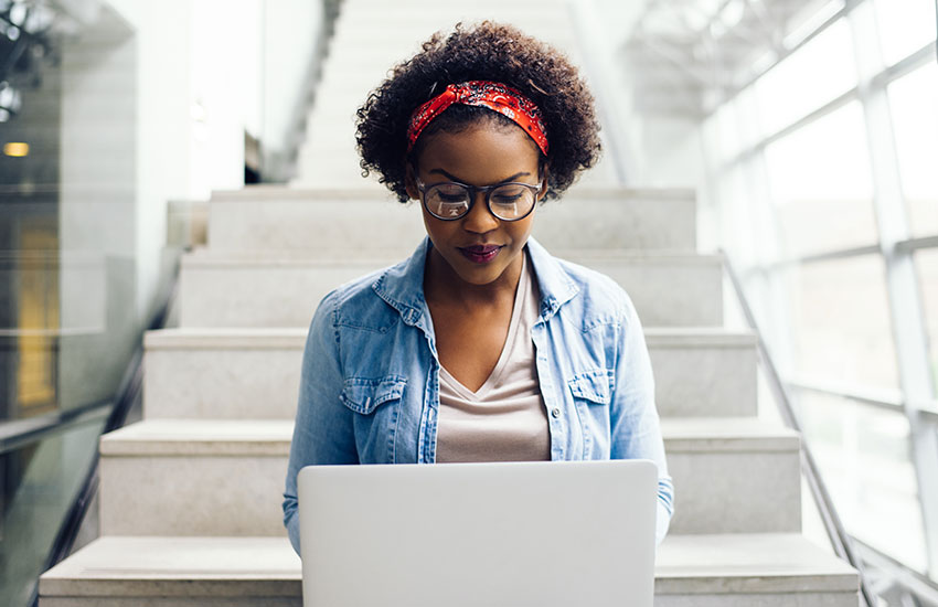 student-with-laptop-on-steps